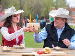 Calgary Stampede Princess Sarah Lambros, left, and Calgary Stampede CEO Joel Cowley tried some of the food at the 2023 Calgary Stampede midway food launch at ENMAX Park on May 10.