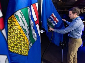 UCP staffer steams flag on Election Day in Calgary.