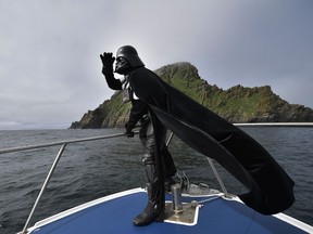 A Star Wars fan dressed as the character Darth Vader takes a boat trip to the Skelligs on Star Wars day May 4, 2018 in Portmagee, Ireland. A Star Wars festival was taking place against the backdrop of the famous Skellig Michael island which was used extensively in Episode VII and Episode VIII of the popular science fiction saga. Charles McQuillan photo; Getty Images.