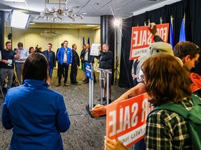 UCP leader Danielle Smith waits as protesters disrupted a press conference in Calgary on Thursday, May 11, 2023.