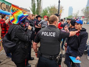 Police work to separate protesters and counter-protesters who clashed outside Western Canada High School on Wednesday, May 17, 2023. A group against LGBTQ rights was met by LGBTQ students and supporters in front of the school.