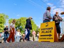 Calgarians in the Calgary-Mountain View line up to vote at Stanley Jones School on provincial election day, Monday, May 29, 2023.