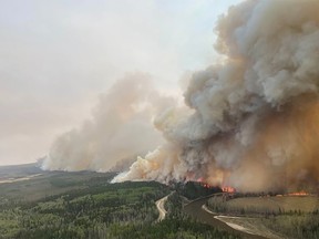 FILE PHOTO: A smoke column rises from wildfire EWF-035 near Shining Bank, Alberta on  May 5, 2023.