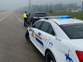 Fox Creek RCMP pull over one of many vehicles that were caught speeding past workers on Highway 43 after speeds had been reduced.
