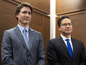 Prime Minister Justin Trudeau stands with Conservative Leader Pierre Poilievre
