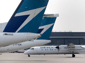 WestJet planes are shown parked at the Calgary International Airport on Thursday.