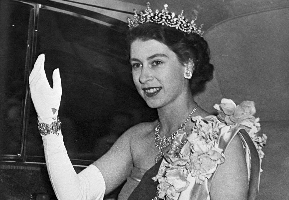 In this file photo taken on June 7, 1951, Princess Elizabeth of Great Britain, the future Queen, with her recognizable wave to the people.