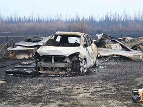 Damaged vehicles sit near the property of Adam Norris, in Drayton Valley, Alberta, Canada, on May 8, 2023. - Canada struggled on Monday to control wildfires that have forced thousands to flee, halted oil production and threaten to raze towns, with the western province of Alberta calling for federal help. (Photo by Walter Tychnowicz / AFP)