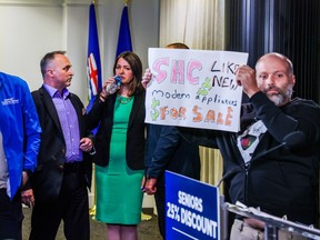 UCP Leader Danielle Smith waits as protesters disrupt a news conference in Calgary on May 11.