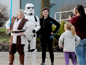 Cindy Harper, dressed as Obi-Wan Kenobi, and Corey Andrews, dressed as a stormtrooper, pose for photos at a 2019 road race in Prescott, Ontario, held in conjunction with a May the fourth be with you theme. Postmedia archives.