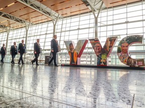 WestJet pilots walk through the Calgary International Airport before an informational picket on May 8.