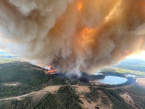 A smoke column rises from wildfire EWF031 near Lodgepole, Alberta, Canada May 4, 2023.