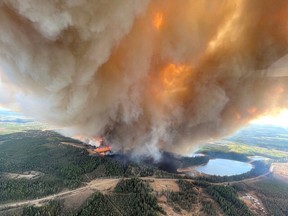 A column of smoke rises from a wildfire near Lodgepole, west of Drayton Valley, on Thursday.
