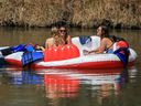 Hot weather this weekend will likely bring more rafts to the Elbow River in Calgary. Here, a group floats down the river on May 3.