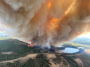 A column of smoke rises from wildfire EWF031 near Lodgepole, east of Drayton Valley, on Thursday, May 4, 2023.