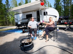 Debbie Wheeler and Tammy Marr enjoy the weather despite a fire ban at the McLean Creek Campground on Friday, May 19, 2023. Alberta's two main political parties were campaigning on Saturday, touting investments in parks and outdoor recreation.