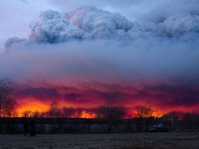 A wildfire moves towards the town of Anzac from Fort McMurray on May 4, 2016.