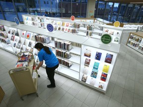 A library worker stocks shelves at the Central Library.