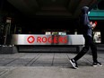 A person walks near the Rogers Communications building in Toronto.