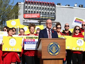 Accompanied by teachers, Jason Schilling, president of the Alberta Teachers' Association, speaks to media in Calgary on Friday, May 5, 2023.