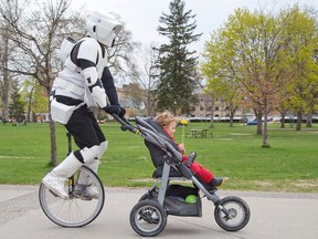 In London, Ont., Brian MacKenzie celebrated Star Wars Day in 2015 on his unicycle with two-year-old son Aidan. Postmedia archives.