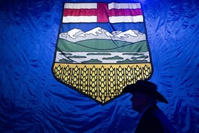 A man in cowboy hat stands in front of a huge Alberta flag at the UCP watch party on the election night at Big Four Building in Calgary on Monday, May 29, 2023. Azin Ghaffari/Postmedia