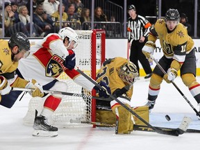 Adin Hill of the Vegas Golden Knights makes a save against Carter Verhaeghe of the Florida Panthers.
