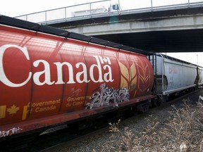 A Canadian Pacific Rail train hauling grain passes through Calgary, Thursday, May 1, 2014. Set to come into effect with the budget bill in Ottawa, an obscure law has Canada's two main railways in a tizzy over concerns around expenses and congestion, with the backlash playing out in social media posts and a back-room lobbying push.