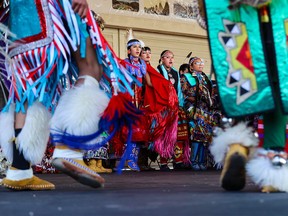 First Nation dancers participate in the grand entry as part of a National Indigenous Peoples Month celebration at Enmax Park on the Calgary Stampede grounds, Saturday, June 24, 2023.