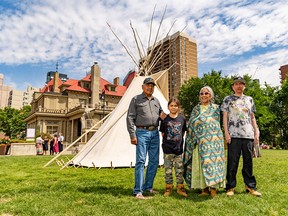 Elder Clarence Wolfleg, left and Elder Joyce Healy stand with Healy’s son Guy and grandson Frank after Kainai First Nation members raised a tipi as part of celebrating National Indigenous Peoples Month at Lougheed House on Sunday, June 25, 2023.