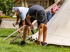 Kainai First Nation members raise a tipi as part of celebrating National Indigenous Peoples Month at Lougheed House on Sunday, June 25, 2023.