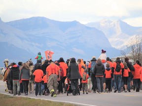 Members of the Stoney Nakoda First Nation mark Orange Shirt Day with a ceremonial walk.