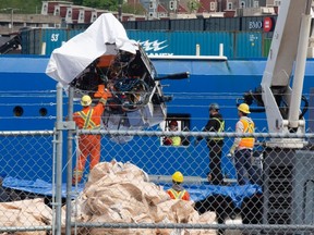 Debris from the Titan submersible, recovered from the ocean floor near the wreck of the Titanic, is unloaded from the ship Horizon Arctic at the Canadian Coast Guard pier in St. John's on June 28, 2023.