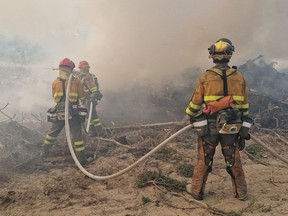 Spanish firefighters near Rivière Boisvert in northern Quebec June 24, 2023. As of June 27, firefighters were battling 494 blazes across Canada, more than half of them classified as out-of-control, according to the Canadian Interagency Forest Fire Centre.