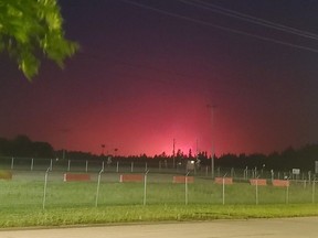 The red glow from a fire is shown in Edson on Friday, June 9, 2023. Officials in Alberta say extreme fire behaviour is anticipated on a wildfire that prompted the evacuation of the town of Edson early Friday evening, and local leaders are urging anyone who has stayed behind to get out now.