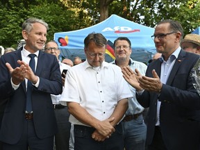 AfD members, Bjorn Hocke, left, Robert Sesselmann, centre, Stephan Brandner, 3rd from left and Tino Chrupalla are photographed at the AfD election party, in Sonneberg, Germany, Sunday, June 25, 2023. Sesselmann has received the most votes in the first round of the run off elections. Alternative for Germany hope to win the political party's first-ever governing post.