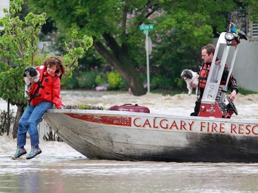 The Calgary Fire Department carries a women and her dogs