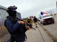 FILE: Members of the Mexican National Guard stand guard outside the airport as authorities transfer inmates from the Cereso 3 prison in Ciudad Juarez to other prisons in the country following an attack where a cartel kingpin escaped along with two dozen other prisoners, according to police, in Ciudad Juarez, Mexico, January 3, 2023.