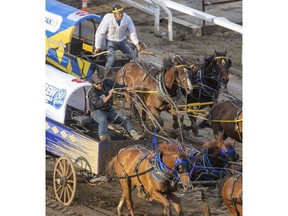 Chance Bensmiller holds off Jamie Laboucane to take Heat 4 of the Rangeland Derby chuckwagon races at the Calgary Stampede in Calgary on Friday. Photo by Mike Drew/Postmedia.