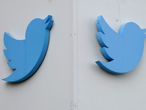 FILE - Twitter logos hang outside the company's offices in San Francisco, on Dec. 19, 2022. Australia's online safety watchdog has on Thursday, June 22, 2023, issued a legal notice to Twitter demanding an explanation of what the social media giant is doing to tackle a surge in online hate since Tesla CEO Elon Musk bought the platform.