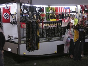 A swastika flag, left, is displayed for sale at a store at the Gladstone Harbour Festival in central Queensland, April 11, 2006. The Australian government would legislate to ban swastikas and other Nazi symbols throughout the nation due to an increase in far right activity, Attorney-General Mark Dreyfus said on Thursday, June 8, 2023.