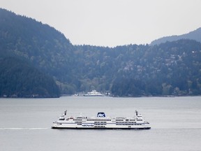 The B.C. Ferries vessel Queen of Surrey passes Bowen Island while traveling on Howe Sound from Horseshoe Bay to Langdale, B.C., on Friday, April 23, 2021. Buffet meals on BC Ferries, put on hold during the COVID-19 pandemic, will no longer be available on voyages to and from B.C.'s Lower Mainland to Vancouver Island.