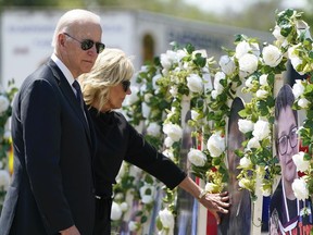 FILE - President Joe Biden and first lady Jill Biden visit a memorial at Robb Elementary School to pay their respects to the victims of the mass shooting, May 29, 2022, in Uvalde, Texas. Biden will speak at a summit in Connecticut on Friday, June 16, 2023, to mark the first anniversary of a gun safety law signed after the school massacre in Uvalde, Texas.
