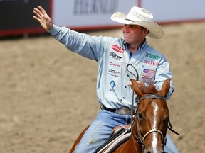 Riley Webb celebrates during his tie-down roping day win at the Calgary Stampede on Sunday, July 9, 2023.