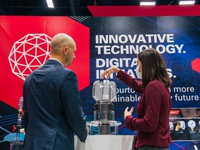 FILE PHOTO: A person receives a demonstration on a Halliburton product during the 23rd World Petroleum Congress conference on December 7, 2021 in Houston, Texas.