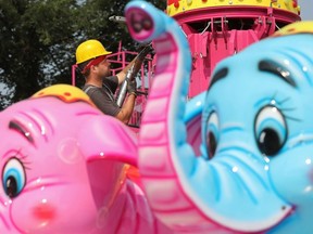 Crews set up rides on Thursday, July 20, 2023, ahead of Friday's opening day at K-Days at the Edmonton Expo Centre.