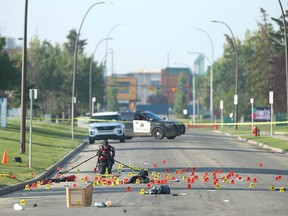 Members of the Calgary Police Service's collision reconstruction unit investigate at the scene of a fatal hit and run at 34 St. and 37 Ave. N.E. in Calgary on Friday, July 21, 2023.