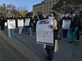 Waving to passing motorists, health-care workers walked off the the job outside the Royal Alexandra Hospital joining others at various health care locations across Alberta on Monday, Oct. 26, 2020.