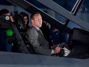 Peter MacKay checks out the cockpit of the F-35 Joint Strike Fighter following an announcement in Ottawa in 2010. The former minister says he regrets not being able to close that deal.