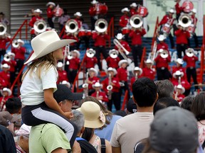 Dad Alec Day and daughter Nova, 7, check out the Stampede Showband during Kids' Day at the Calgary Stampede in Calgary on Wednesday, July 12, 2023.